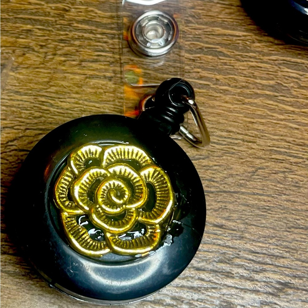 Self retracting ID badge with flower detail